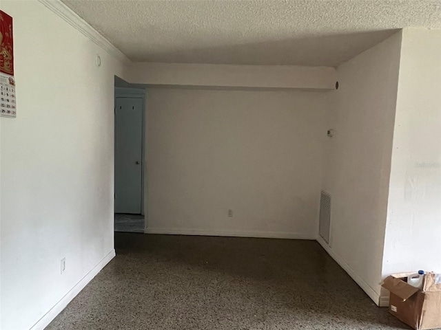 1009 Kenmore Dr, Brandon, FL 33510 - empty room with a textured ceiling, speckled floor, and baseboards