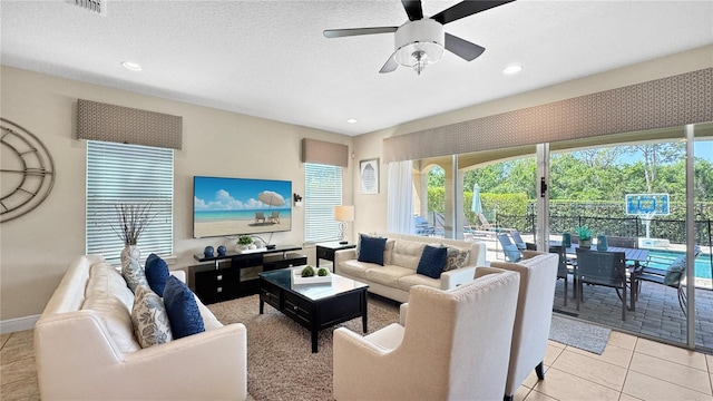 1228 Castle Pines Ct, Reunion, FL 34747 - living room with a ceiling fan, healthy amount of natural light, recessed lighting, light tile patterned floors, and baseboards