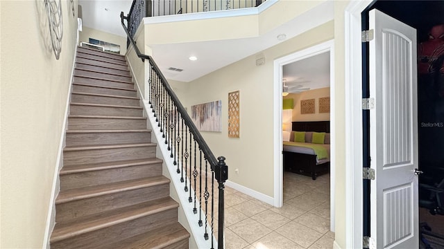 1228 Castle Pines Ct, Reunion, FL 34747 - staircase featuring tile patterned flooring, a ceiling fan, and baseboards