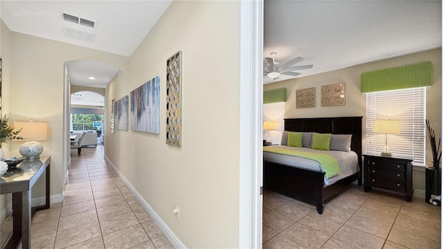 1228 Castle Pines Ct, Reunion, FL 34747 - hallway featuring arched walkways, light tile patterned floors, and baseboards