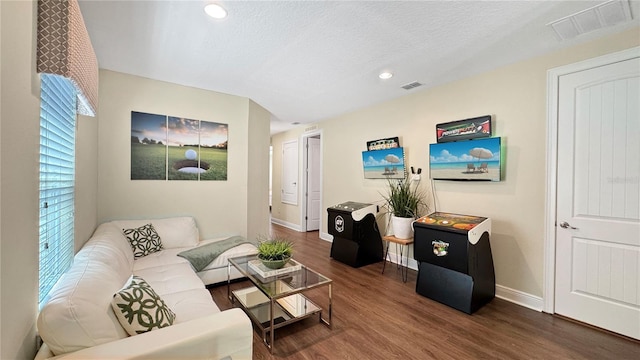 1228 Castle Pines Ct, Reunion, FL 34747 - living room with wood finished floors, baseboards, recessed lighting, and a textured ceiling