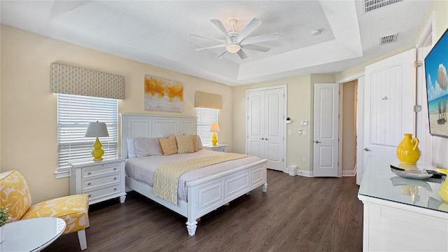 1228 Castle Pines Ct, Reunion, FL 34747 - bedroom with a raised ceiling, dark wood finished floors, a closet, and ceiling fan