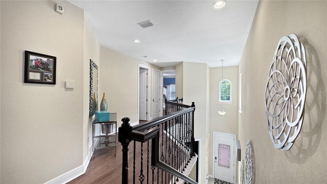 1228 Castle Pines Ct, Reunion, FL 34747 - corridor with an upstairs landing, baseboards, wood finished floors, a textured ceiling, and recessed lighting