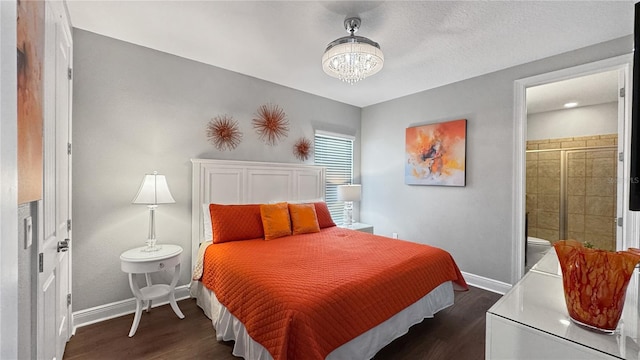 1228 Castle Pines Ct, Reunion, FL 34747 - bedroom with dark wood-type flooring, baseboards, a chandelier, and ensuite bath