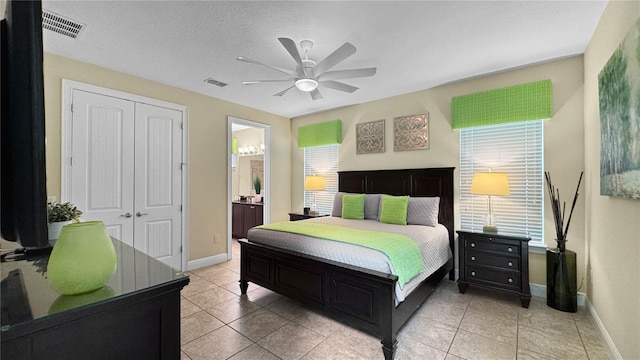 1228 Castle Pines Ct, Reunion, FL 34747 - bedroom featuring a closet, baseboards, light tile patterned floors, and a ceiling fan