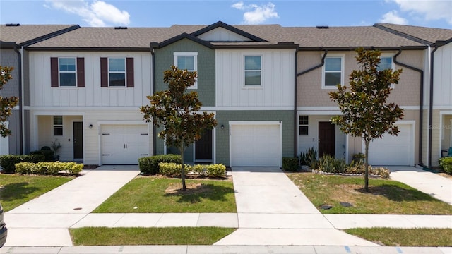 1113 Merrill St, Davenport, FL 33837 - view of property featuring board and batten siding, a shingled roof, and a front lawn