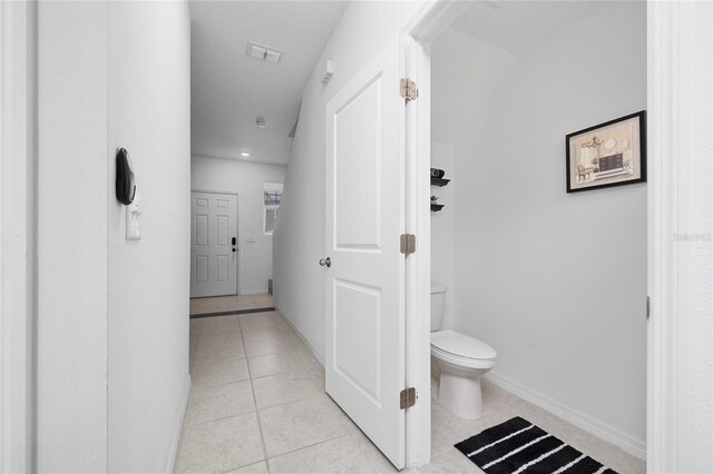 1113 Merrill St, Davenport, FL 33837 - bathroom with toilet, tile patterned flooring, and baseboards