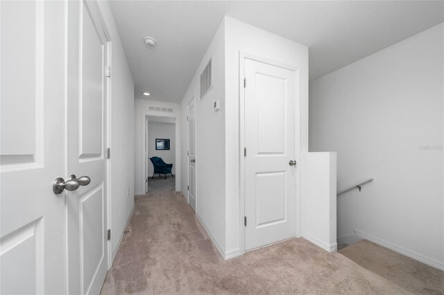 1113 Merrill St, Davenport, FL 33837 - corridor featuring light carpet, an upstairs landing, and baseboards