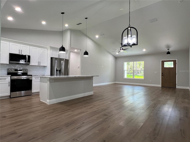 814 Gator Ln, Deltona, FL 32738 - kitchen featuring stainless steel appliances, a chandelier, white cabinets, open floor plan, and a kitchen island