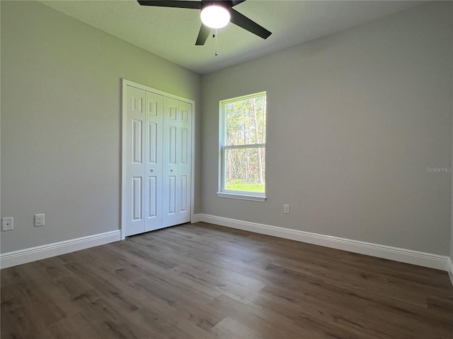 814 Gator Ln, Deltona, FL 32738 - unfurnished bedroom with dark wood-type flooring, baseboards, and a closet