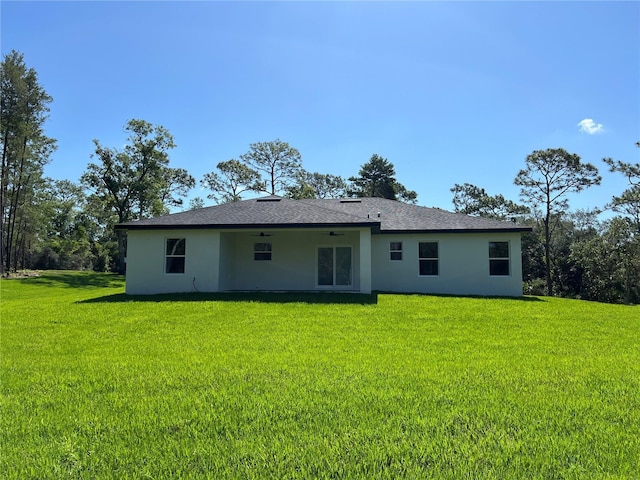 814 Gator Ln, Deltona, FL 32738 - rear view of property featuring stucco siding, a yard, a ceiling fan, and roof with shingles