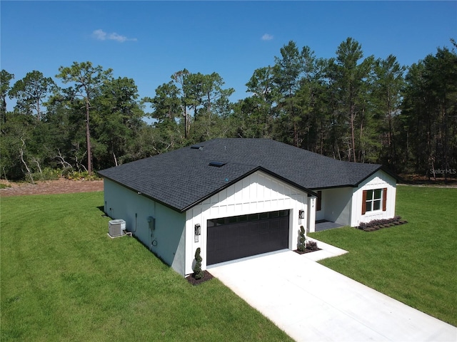 814 Gator Ln, Deltona, FL 32738 - view of front of house featuring central AC unit, roof with shingles, an attached garage, a front yard, and driveway
