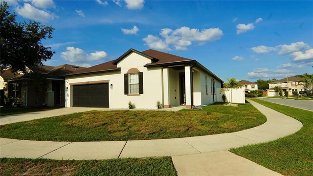 1025 Belvoir Dr, Kissimmee, FL 34744 - ranch-style home with stucco siding, a front lawn, a garage, and concrete driveway