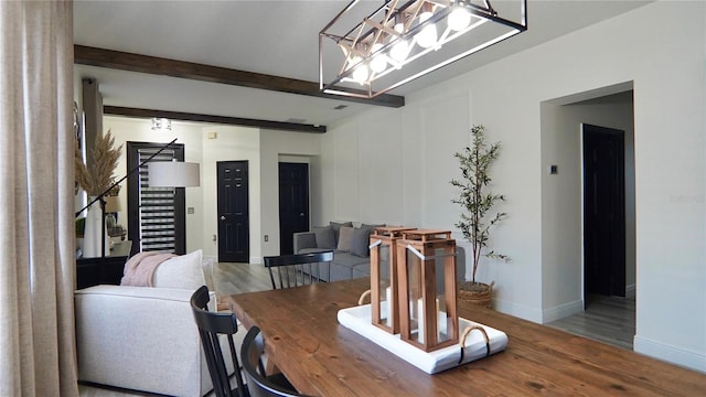 1025 Belvoir Dr, Kissimmee, FL 34744 - dining room featuring a chandelier, wood finished floors, stairs, beam ceiling, and baseboards