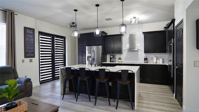 1025 Belvoir Dr, Kissimmee, FL 34744 - kitchen featuring wall chimney exhaust hood, stainless steel refrigerator with ice dispenser, light countertops, and backsplash