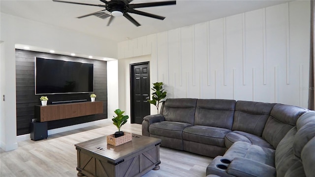 1025 Belvoir Dr, Kissimmee, FL 34744 - living area featuring a ceiling fan, light wood-style flooring, and baseboards