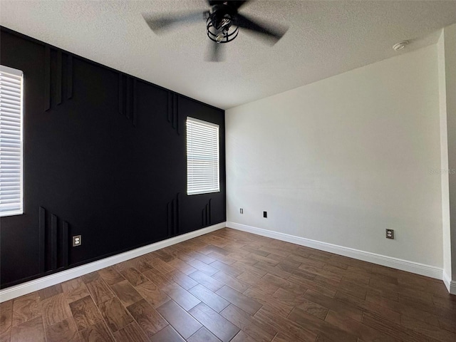 1025 Belvoir Dr, Kissimmee, FL 34744 - spare room featuring a ceiling fan, a textured ceiling, baseboards, and dark wood finished floors