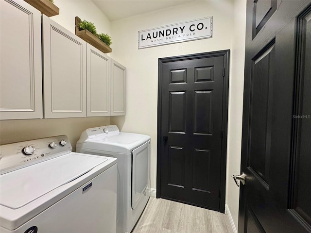 1025 Belvoir Dr, Kissimmee, FL 34744 - laundry room featuring washer and dryer, cabinet space, light wood-style flooring, and baseboards