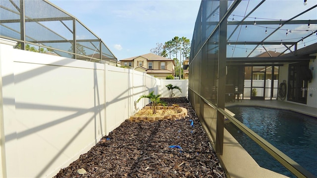 1025 Belvoir Dr, Kissimmee, FL 34744 - fenced backyard with a lanai, an outdoor pool, and a patio area