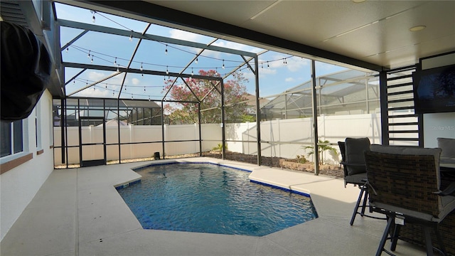 1025 Belvoir Dr, Kissimmee, FL 34744 - view of pool featuring a patio, a fenced backyard, and glass enclosure