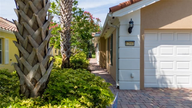 12041 Kajetan Ln, Orlando, FL 32827 - view of property exterior featuring stucco siding and an attached garage
