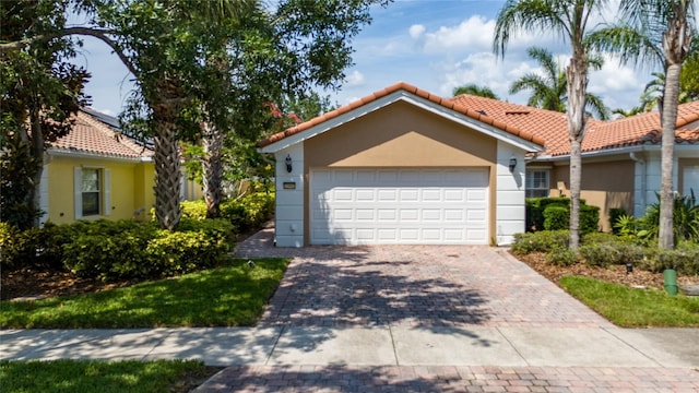 12041 Kajetan Ln, Orlando, FL 32827 - view of front of property featuring a tile roof, decorative driveway, an attached garage, and stucco siding