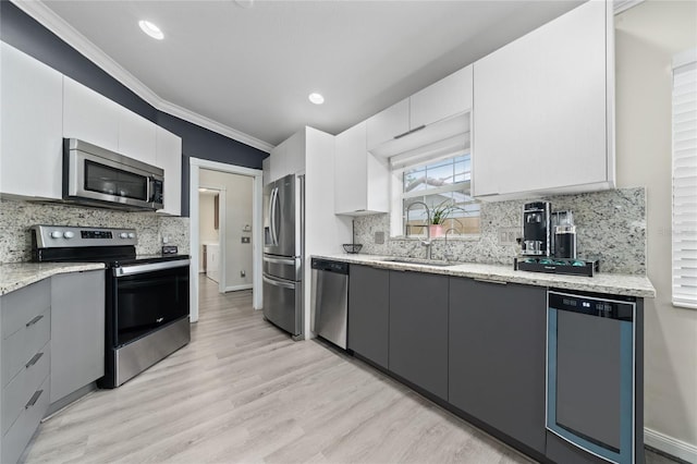 12041 Kajetan Ln, Orlando, FL 32827 - kitchen featuring stainless steel appliances, a sink, crown molding, light stone countertops, and white cabinets