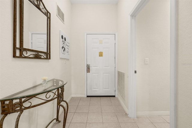 9055 Treasure Trove Ln Unit 409, Kissimmee, FL 34747 - foyer entrance featuring light tile patterned floors and baseboards