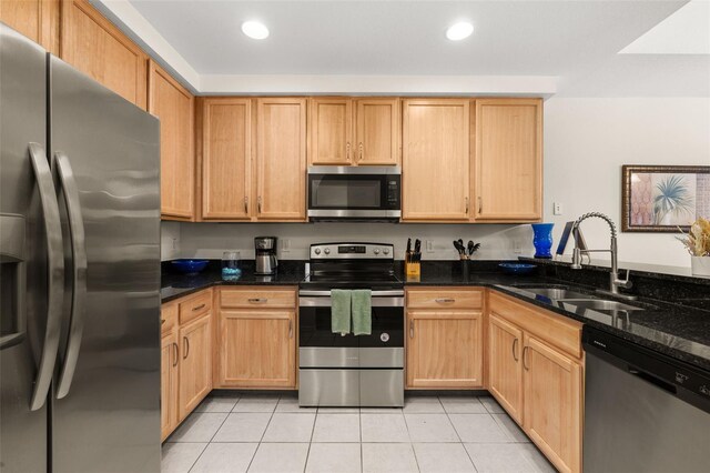 9055 Treasure Trove Ln Unit 409, Kissimmee, FL 34747 - kitchen with appliances with stainless steel finishes, a sink, light tile patterned floors, dark stone counters, and recessed lighting