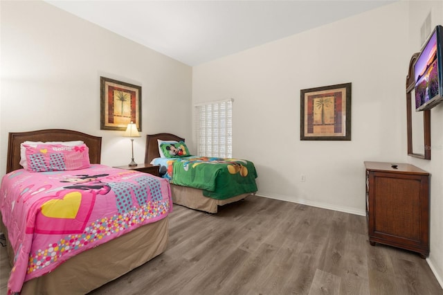9055 Treasure Trove Ln Unit 409, Kissimmee, FL 34747 - bedroom featuring wood finished floors and baseboards