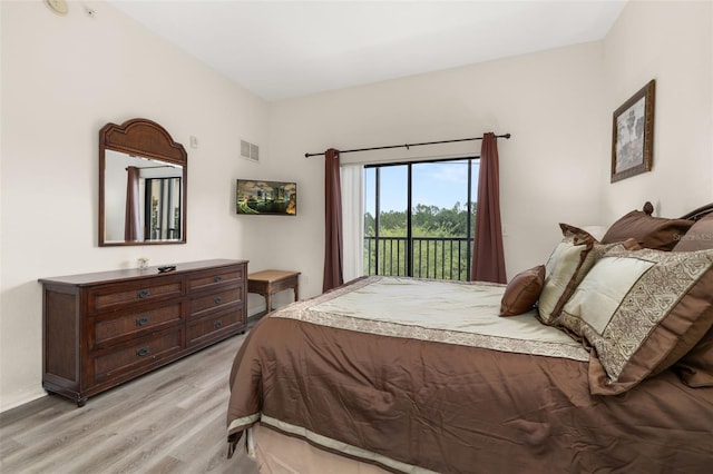 9055 Treasure Trove Ln Unit 409, Kissimmee, FL 34747 - bedroom with light wood-type flooring, access to exterior, and baseboards