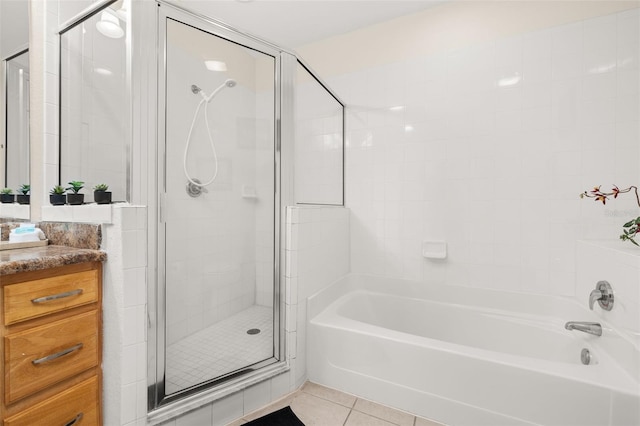 9055 Treasure Trove Ln Unit 409, Kissimmee, FL 34747 - bathroom featuring a shower stall, a garden tub, tile patterned flooring, and vanity