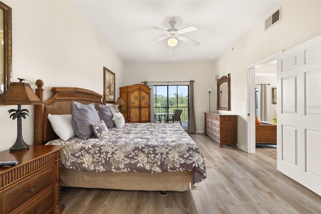 9055 Treasure Trove Ln Unit 409, Kissimmee, FL 34747 - bedroom with access to exterior, wood finished floors, and ceiling fan