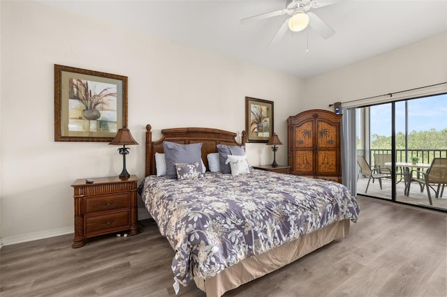 9055 Treasure Trove Ln Unit 409, Kissimmee, FL 34747 - bedroom featuring access to exterior, wood finished floors, baseboards, and ceiling fan