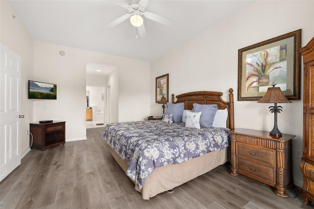 9055 Treasure Trove Ln Unit 409, Kissimmee, FL 34747 - bedroom featuring wood finished floors, baseboards, ensuite bathroom, and a ceiling fan