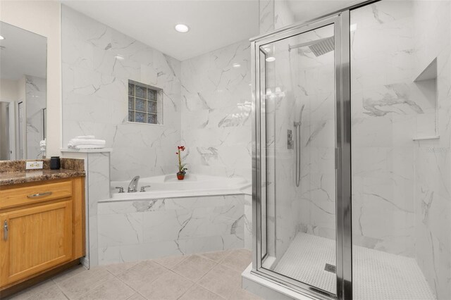 9055 Treasure Trove Ln Unit 409, Kissimmee, FL 34747 - bathroom featuring a garden tub, vanity, a marble finish shower, and recessed lighting