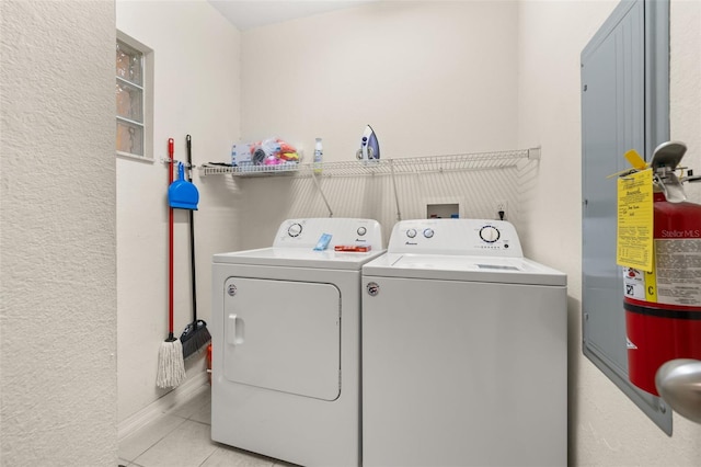 9055 Treasure Trove Ln Unit 409, Kissimmee, FL 34747 - laundry room with independent washer and dryer, tile patterned flooring, and a textured wall