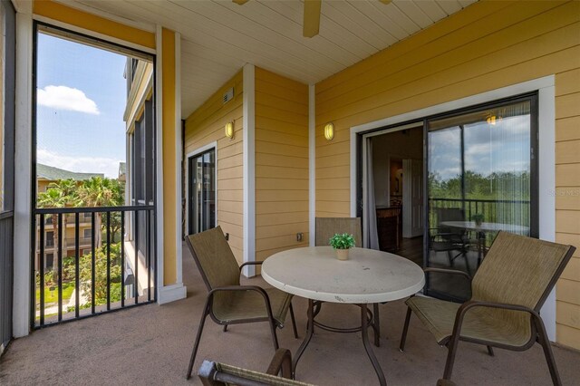 9055 Treasure Trove Ln Unit 409, Kissimmee, FL 34747 - balcony with a ceiling fan and outdoor dining space
