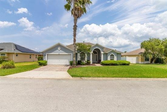 252 Barbera Dr, Davenport, FL 33897 - ranch-style house with an attached garage, concrete driveway, and a front lawn