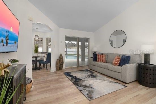 252 Barbera Dr, Davenport, FL 33897 - living area with wood finished floors and lofted ceiling