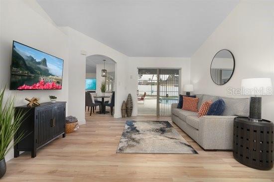 252 Barbera Dr, Davenport, FL 33897 - living room with arched walkways and wood finished floors