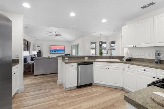 252 Barbera Dr, Davenport, FL 33897 - kitchen featuring stainless steel appliances, a sink, a peninsula, open floor plan, and a ceiling fan
