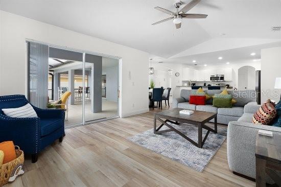 252 Barbera Dr, Davenport, FL 33897 - living area featuring a ceiling fan, vaulted ceiling, and light wood finished floors