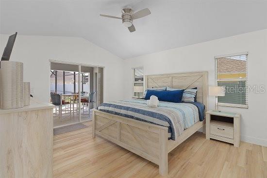 252 Barbera Dr, Davenport, FL 33897 - bedroom featuring lofted ceiling, access to exterior, light wood finished floors, baseboards, and ceiling fan