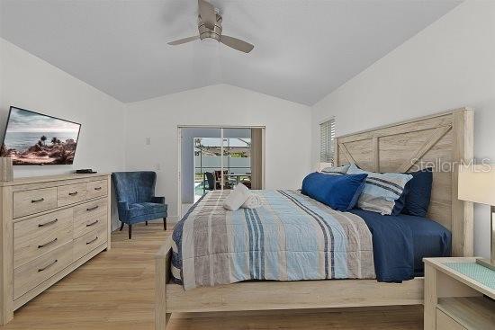 252 Barbera Dr, Davenport, FL 33897 - bedroom with lofted ceiling, access to exterior, light wood-style flooring, and ceiling fan