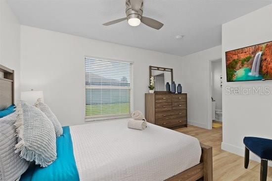 252 Barbera Dr, Davenport, FL 33897 - bedroom with wood finished floors, baseboards, and ceiling fan