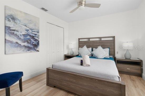 252 Barbera Dr, Davenport, FL 33897 - bedroom featuring light wood-style floors, baseboards, a closet, and a ceiling fan