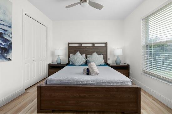 252 Barbera Dr, Davenport, FL 33897 - bedroom featuring multiple windows, light wood-type flooring, and ceiling fan