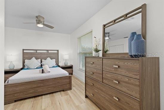 252 Barbera Dr, Davenport, FL 33897 - bedroom featuring light wood finished floors, a ceiling fan, and baseboards