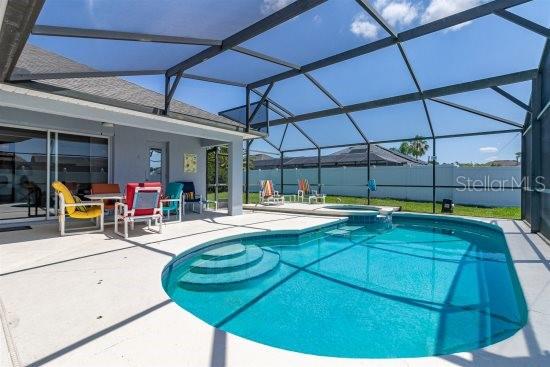 252 Barbera Dr, Davenport, FL 33897 - view of pool with a patio, glass enclosure, and a pool with connected hot tub